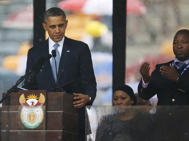 President Obama looks down as he stands next to the sign-language interpreter as he makes his speech at the memorial service for former South African President Nelson Mandela at FNB Stadium in Soweto near Johannesburg Dec. 10, 2013. 