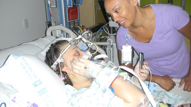 Post surgery in bed with Nurse.JPG 