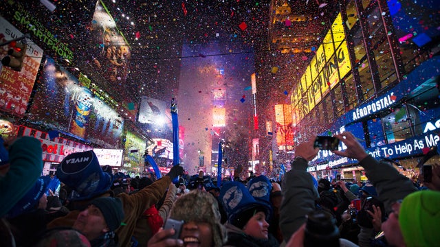 Revelers cheer under falling confetti at the stroke of midnight during the New Year's Eve celebrations in Times Square 