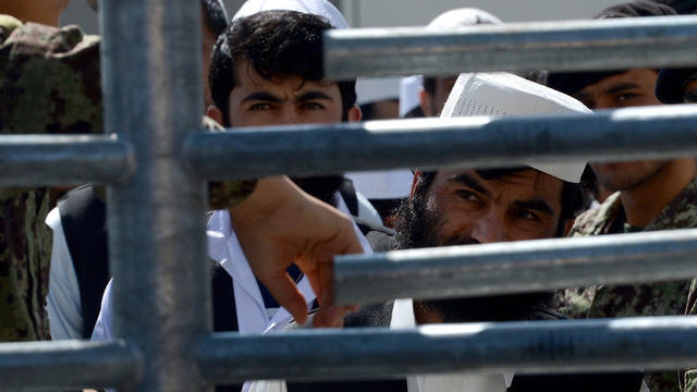 Afghan detainees wait to be released during a ceremony to hand over Bagram prison to the Afghanistan government at Bagram Prison facilities 