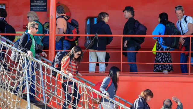 Passengers disembark from the Aurora Australis in Hobart, Australia, Jan. 22, 2014, following their rescue from a ship trapped in ice in the Antarctic 
