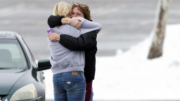 Two people embrace in the parking lot at the scene of a shooting at The Mall in Columbia Jan. 25, 2014, in Columbia, Md. 