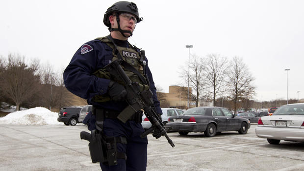 Police move in from a parking lot to the Mall in Columbia after a multiple shooting Jan. 25, 2014, in Howard County, Md. 