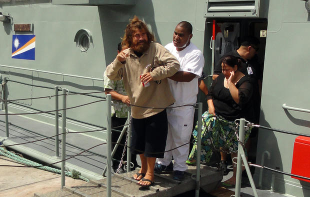A castaway from Mexico who identified himself as Jose Salvador Alvarenga steps off the "Lomor" Sea Patrol vessel in Majuro, Marshall Islands, with the help of a nurse 