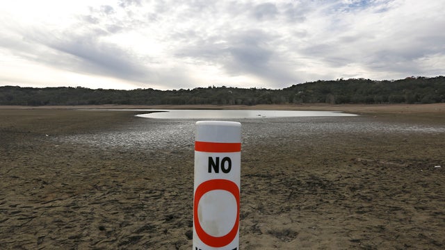 A warning buoy sits on the dry, cracked bed of Lake Mendocino near Ukiah, Calif., Feb. 4, 2014, amid an historic drought. 