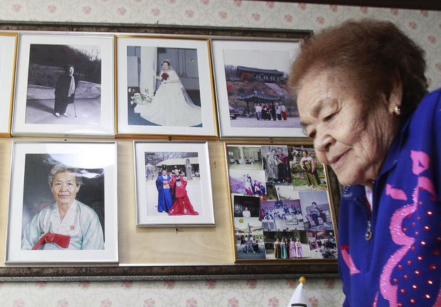 Kim Gun-ja, former comfort woman who was forced to serve for the Japanese troops as a sex slave during World War II, passes by her wedding picture 