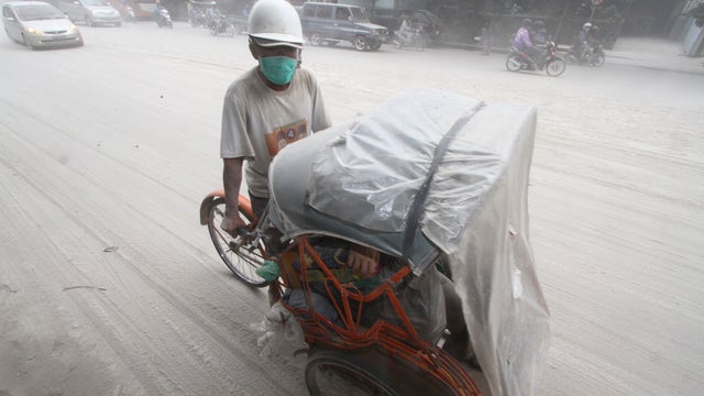 A pedicab on the street are covered with volcanic ash from an eruption of Mount Kelud 
