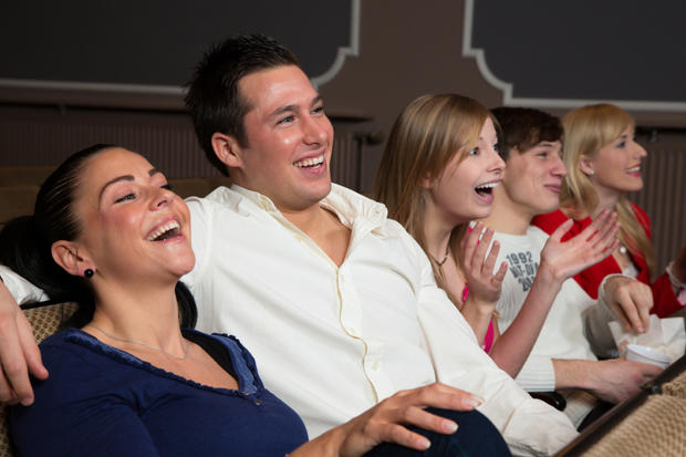 Laughing comedy audience at the movies 