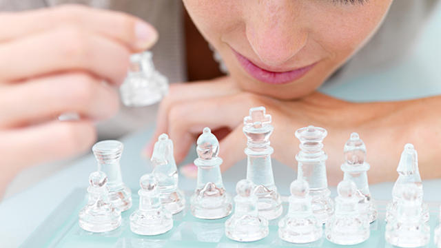 woman_clear_chess_pieces.jpg 