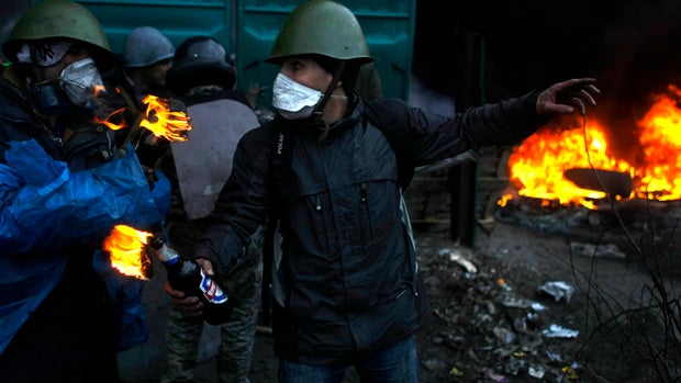 Anti-government protesters get ready to throw petrol bombs on the outskirts of Independence Square in Kiev, Ukraine, Feb. 20, 2014. 