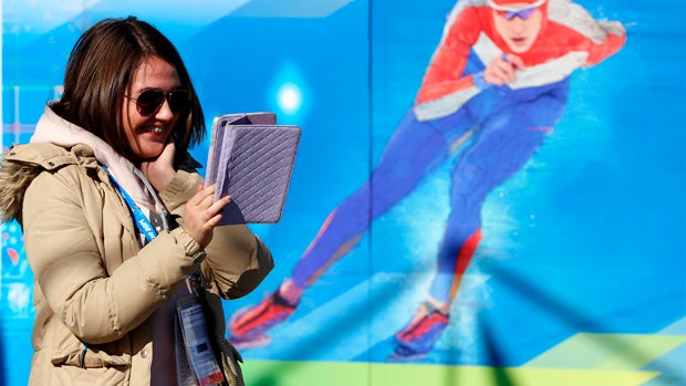 A woman speaks to somebody via a tablet computer ahead of the team welcome ceremony Feb. 6, 2014, prior to the start of the 2014 Sochi Winter Olympic Games. 