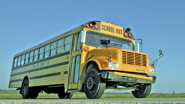 A school bus travels down a rural highway near Leroy, Kan., May 16, 2006. 