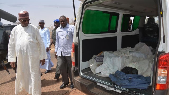 Ibrahim Gaidam, Governor of Yobe state, left, looks at bodies of students inside an ambulance outside a mosque in Damaturu, Nigeria 