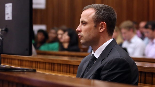 Oscar Pistorius, foreground, sits in the dock during his trial at the high court in Pretoria 
