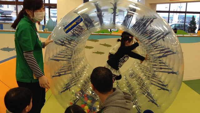 Parents look on as their children play at the indoor "Pep Kids Koriyama" play space 