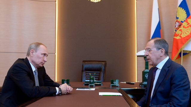 Russian President Vladimir Putin, left listens to Foreign Minister Sergey Lavrov 