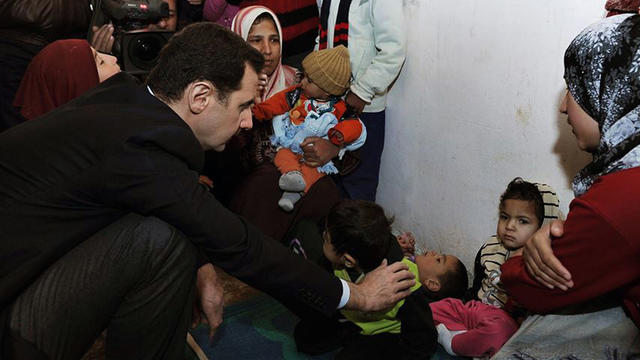 Syrian president Bashar Assad visits a shelter for internally displaced people in the Damascus suburb of Adra. 