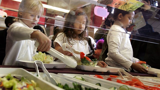 Students at Nettelhorst Elementary School, on lunch, dig into a salad bar in the school's lunchroom March 20, 2006 in Chicago, Illinois.  