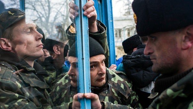 Ukrainian servicemen defend the entrance of the Ukrainian navy headquarters in Sevastopol, Crimea, March 19, 2014. 