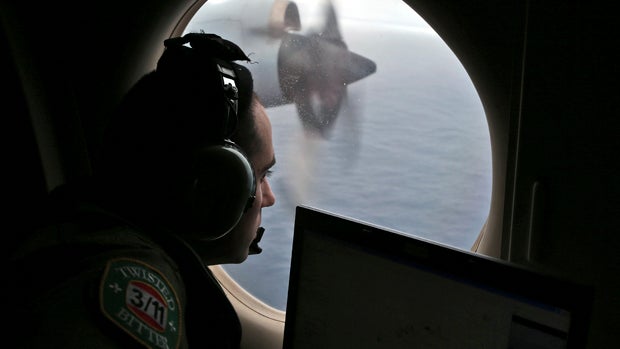 Flight officer Rayan Gharazeddine, on board a Royal Australian Air Force AP-3C Orion, searches for missing Malaysia Airlines Flight 370 in the southern Indian Ocean March 22, 2014. 