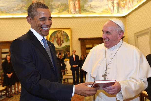 Pope Francis and President Obama smile as they exchange gifts at the Vatican 
