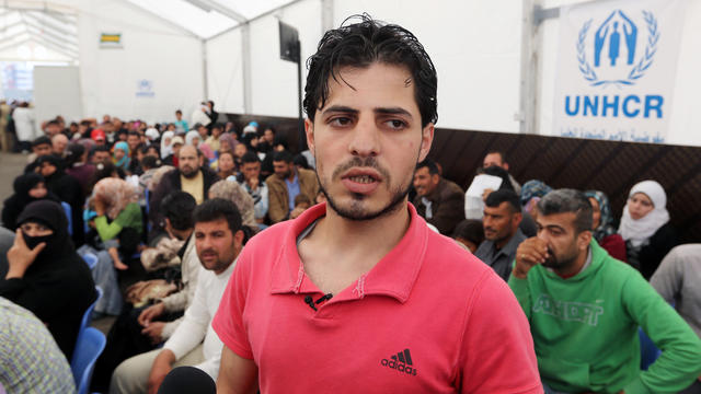 Syrian refugee Yahya, speaks to journalists at the United Nations High Commissioner for Refugees (UNHCR) registration center in the northern city of Tripoli 