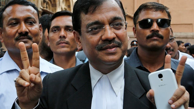 Public Prosecutor Ujjwal Nikam displays the victory symbol as he comes out of a court in Mumbai 