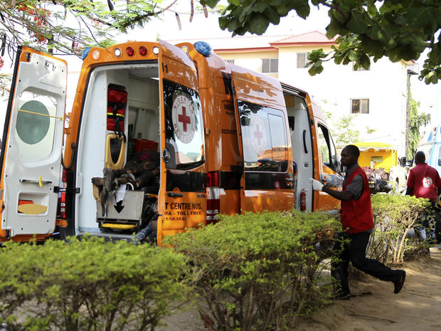 A Red Cross worker runs towards an ambulance carrying victims of a bomb blast at the Asokoro General Hospital in Abuja 