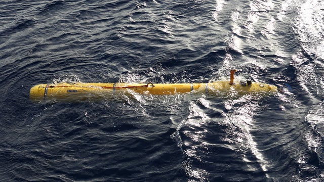 The Phoenix Autonomous Underwater Vehicle (AUV) Bluefin-21 in the water after being craned over the side of Australian Defence Vessel Ocean Shield to begin using its side scan sonar in the search for the missing Malaysia Airlines flight MH370 