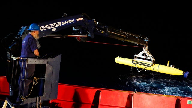 Evan Tanner uses a crane to lift the Bluefin-21 robotic submarine back onto the Australian Defense Vessel Ocean Shield after searching for missing Malaysia Airlines Flight MH370 in the Indian Ocean 