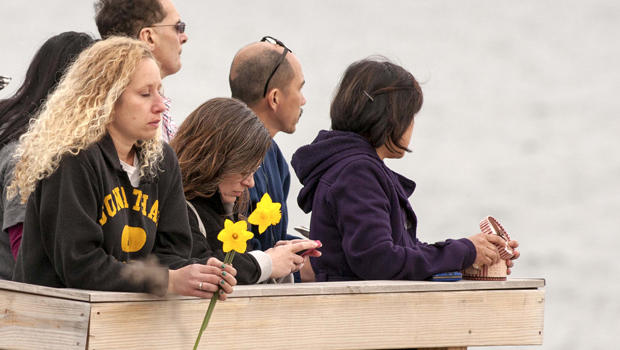 People gather on the beach for a vigil in honor of slain student Maren Sanchez in Milford, Connecticut, April 25, 2014. 