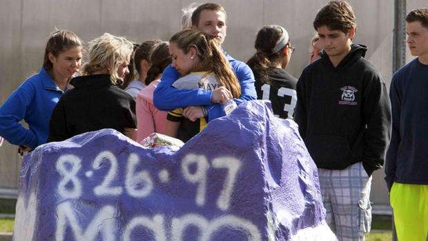 Students mourn in front of Jonathan Law High School in Milford, Connecticut, April 25, 2014. A 16-year-old girl was killed in an attack inside the school. 