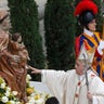 Pope Francis touches the statue of the Virgin Mary as he arrives for the canonization ceremony of Popes John XXIII and John Paul II in St. Peter's Square 
