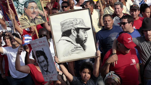 A child holds a poster of Cuba's former president, Fidel Castro, during a May Day parade in Havana May 1, 2014. 