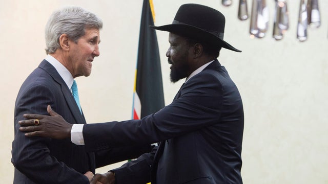 South Sudan's President Salva Kiir Mayardit (R) shakes hands with U.S. Secretary of State John Kerry at the President's Office in Juba  