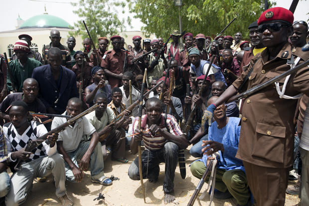 A vigilante group of traditional hunters poses for a picture at its camp in Maiduguri, Nigeria, May 21, 2014. 
