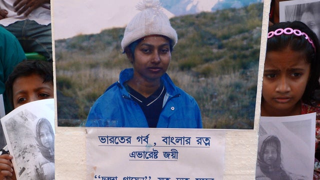 Indian children hold pictures of Mount Everest summiter, mountaineer Chhanda Gayen during a religious prayer organised for her wellbeing in Kolkata 