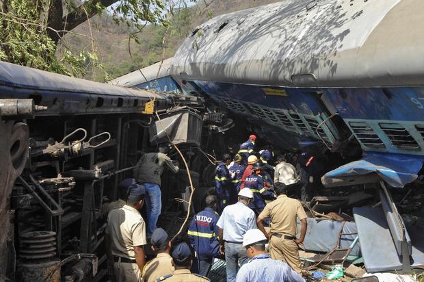 Rescuers search for survivors from the debris of a passenger train after it derailed near Nidi village, south of Mumbai, in the western Indian state of Maharashtra 