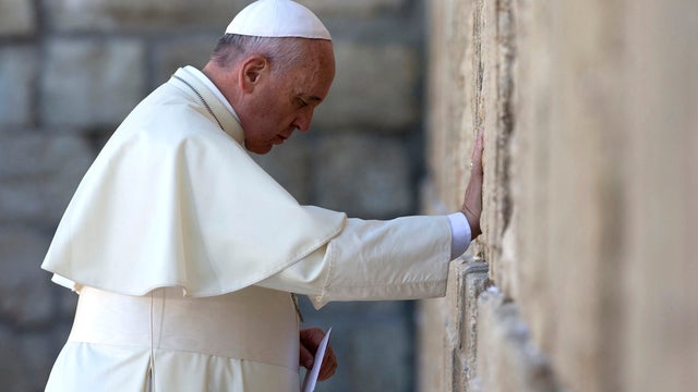 Pope Francis touches the stones of the Western Wall, Judaism's holiest prayer site, in Jerusalem's Old City 