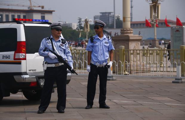 Armed police stand guard at Tiananmen Square in Beijing 