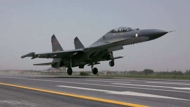 A Chinese military fighter jet takes off from a highway during a test of a highway airstrip 