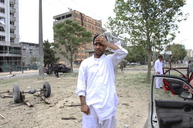 man reacts at the site of a suicide attack that struck the convoy of presidential candidate Abdullah Abdullah 