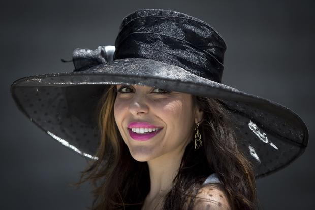 Kellee Khalil poses for a portrait with her hat before the 146th running of the 2014 Belmont Stakes in Elmont, New York, June 7, 2014. 