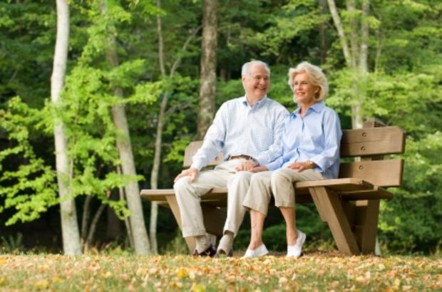 elderly couple married sitting bench 