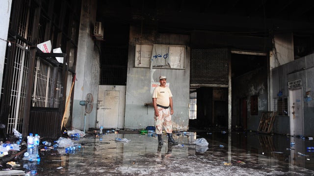 A Pakistani Ranger stands guard at the fire-damaged premises of a cold-storage cargo facility  