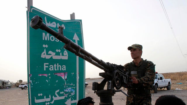 Members of the Kurdish security forces take part in an intensive security deployment on the outskirts of Kirkuk, Iraq, June 12, 2014. 