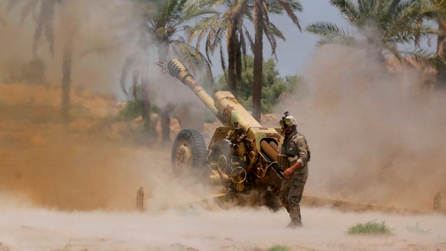 Iraqi security forces fire artillery during clashes with Sunni militant group Islamic State of Iraq and Syria (ISIS) in Jurf al-Sakhar 