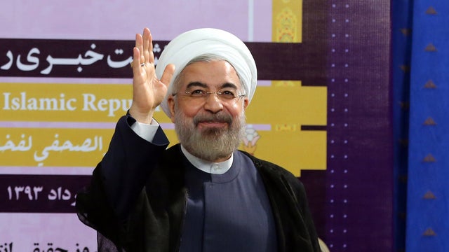 Iranian President Hassan Rouhani waves as he leaves after holding a press conference in the capital Tehran 