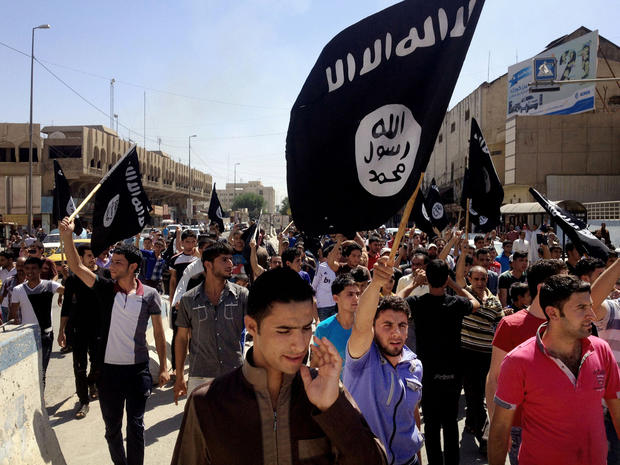 Demonstrators chant in support of al Qaeda-inspired Islamic State of Iraq and Syria as they carry al Qaeda flags in front of the provincial government headquarters in Mosul, Iraq, 225 miles northwest of Baghdad, June 16, 2014. 