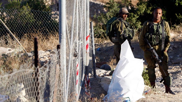 Israeli soldiers keep guard near the West Bank city of Hebron 